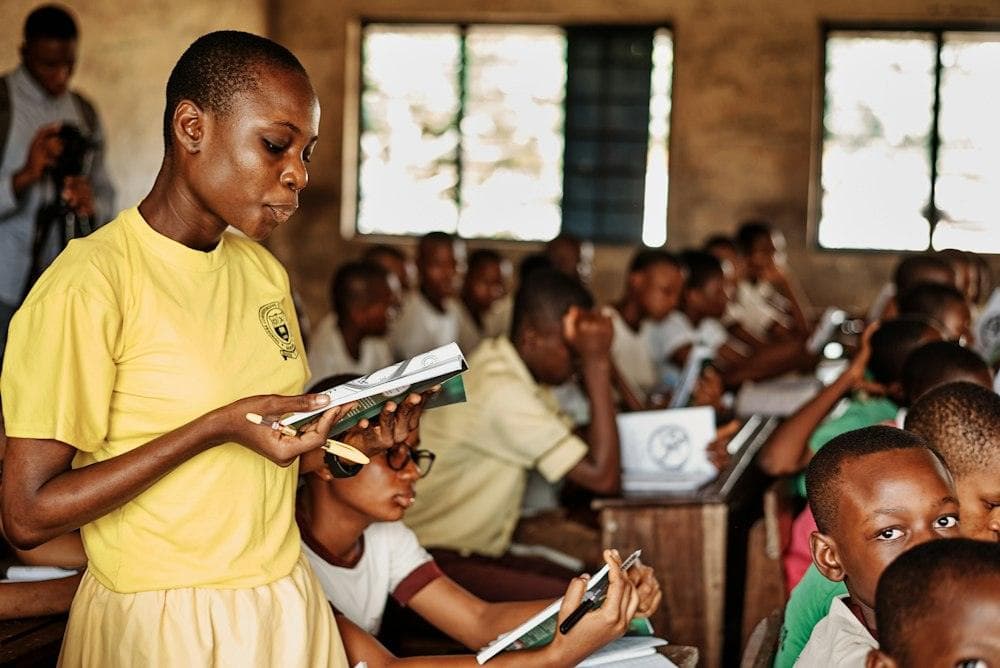 A girl reading in a crowded classroom