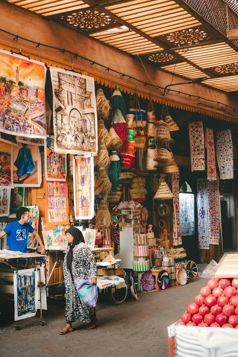 A crafts market stall with masks and paintings