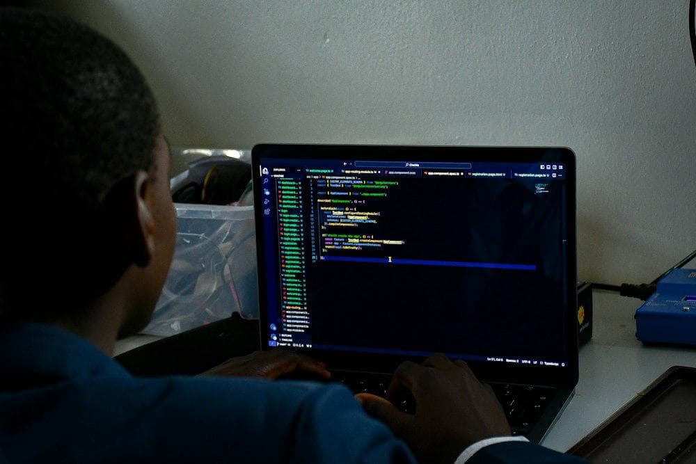 A person coding on a laptop